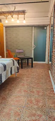 a room with a bed and a table and a couch at Balkan Rooms & Studios in Downtown in Sofia