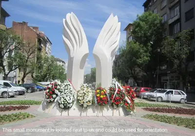 a large white monument with flowers on a city street at Balkan Rooms & Studios in Downtown in Sofia