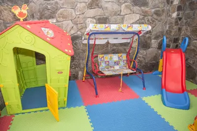 a pretend play room with a table and a play house at Villa Zaburdo in Zabŭrdo