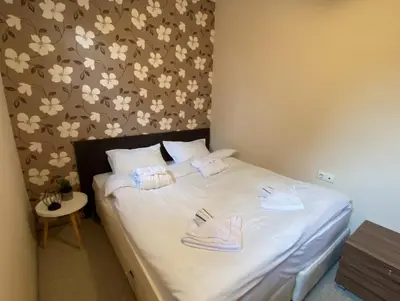 a bedroom with a bed with towels on it at Green life Bansko, 1 bedroom private apartment D4 in Bansko