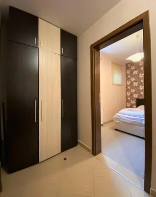 a room with a door open to a bedroom with a bed at Green life Bansko, 1 bedroom private apartment D4 in Bansko