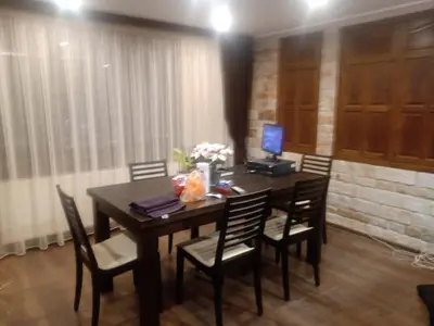 a dining room table with chairs and a computer on it at КръчмЪ При Байката in Ribarica