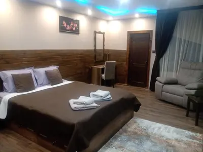 a bedroom with a bed with towels on it at КръчмЪ При Байката in Ribarica
