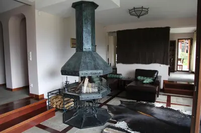 a fireplace in a living room with a couch at Ski & Spa Chalet Bansko in Bansko