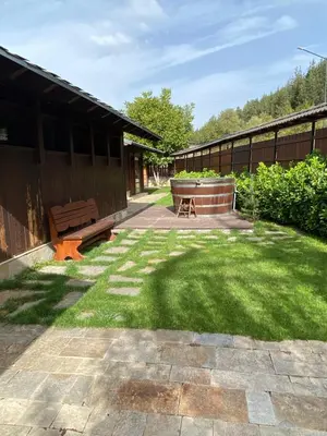 a patio with a bench and a yard at Kameno in Banya