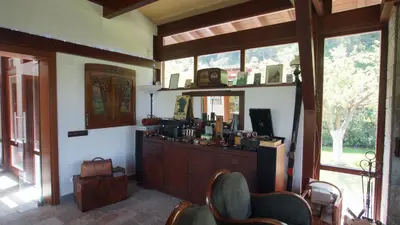 a room with a counter and some chairs and windows at Kameno in Banya
