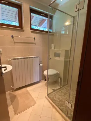 a bathroom with a glass shower and a toilet at Kameno in Banya