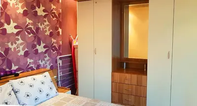 a bedroom with a bed and a dresser and a mirror at Apartment Nicole in Plovdiv