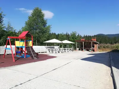 a playground with a slide and a pavilion at Dobi's Apartment Elit47 at Elit Pamporovo in Pamporovo