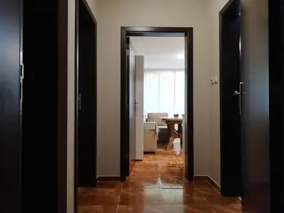 a hallway with two open doors and a living room at Dobi's Apartment Elit47 at Elit Pamporovo in Pamporovo