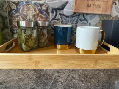 two mason jars and two cups on a wooden tray at Stoykite Escape House in Stoykite
