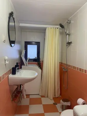 a bathroom with a sink and a toilet and a shower at Stoykite Escape House in Stoykite