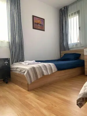 a bedroom with a large bed with blue sheets at Stoykite Escape House in Stoykite