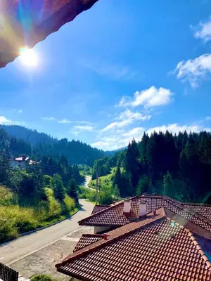 a view of a roof of a building with a rainbow in the sky at Stoykite Escape House in Stoykite
