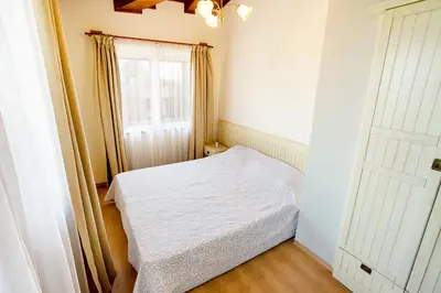 a small bedroom with a bed and a window at Mountain View Pirin Golf in Bansko