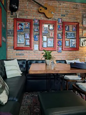 a living room with a couch and a table and a guitar at Mountain View Pirin Golf in Bansko