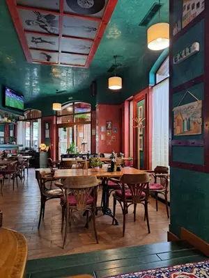a restaurant with wooden tables and chairs in a room at Mountain View Pirin Golf in Bansko