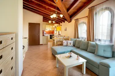 a living room with a blue couch and a table at Mountain View Pirin Golf in Bansko