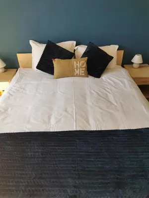 a large white bed with pillows on top of it at Na planina in Razlog