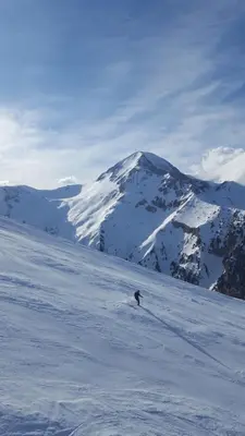 a person is skiing down a snow covered mountain at Na planina in Razlog