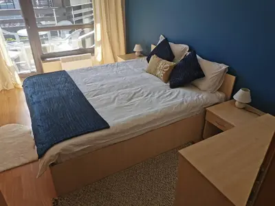 a bed with pillows on it in a bedroom at Na planina in Razlog