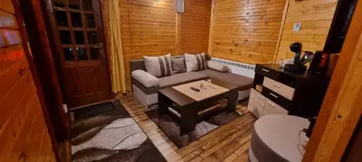 a small room with a couch and a table at The Green King in Borovets
