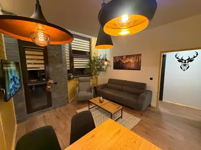 a living room with a couch and a table at Flora Hotel Apartment 103 in Borovets