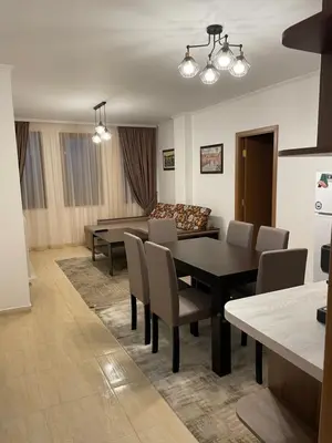 a dining room with a table and chairs and a couch at Гранд Манастира , Пампорово in Pamporovo