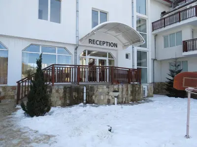 a white building with aederation sign in the snow at Panoramic Apartment 301 in Eagle Rock Complex in Beli Iskar