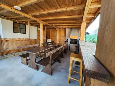 a group of benches in a room with wooden ceilings at Villa 