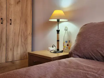 a bedroom with a bed and a lamp on a night stand at Villa 