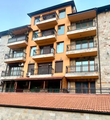 an apartment building with balconies and a red roof at ,,Адела”-апартамент за гости in Velingrad