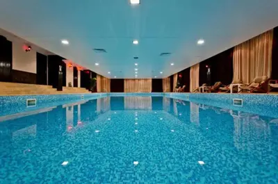 a large swimming pool in a hotel at Grand Monastery Deluxe Pamporovo 5 B 3 in Pamporovo
