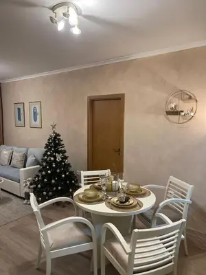 a living room with a table with a christmas tree at Grand Monastery Deluxe Pamporovo 5 B 3 in Pamporovo