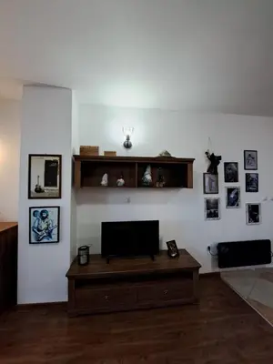 a living room with a flat screen tv on a white wall at Winslow Highland Bansko - Apartment Giovanni, ул Валевица 7 кв Грамадето in Bansko