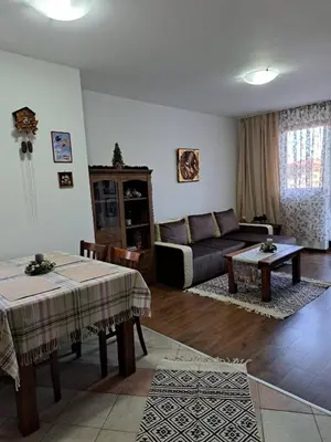 a living room with a couch and a table at Winslow Highland Bansko - Apartment Giovanni, ул Валевица 7 кв Грамадето in Bansko