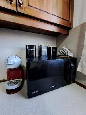 a microwave sitting on top of a kitchen counter at Winslow Highland Bansko - Apartment Giovanni, ул Валевица 7 кв Грамадето in Bansko