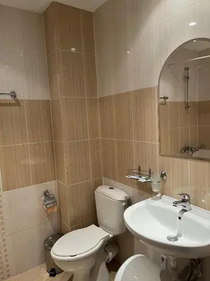 a bathroom with a toilet and a sink at Стаи и апартаменти под наем in Borovets