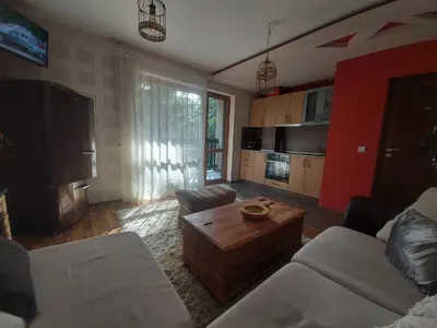 a living room with a couch and a table at 1 Bedroom cozy flat in Pamporovo
