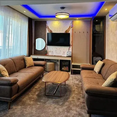 a living room with a couch and a tv at Hotel Diamant in Dospat