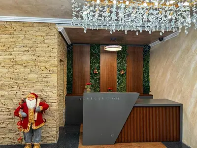 a statue of santa claus standing next to a reception desk at Hotel Diamant in Dospat