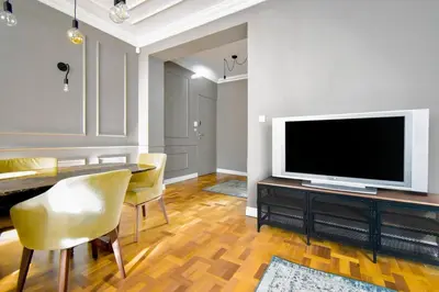 a living room with a television and a dining table at 2bdr Luxury On Prime Location in Sofia