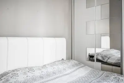 a white bedroom with a bed and a mirror at 2bdr Luxury On Prime Location in Sofia