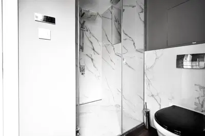 a bathroom with a toilet and a glass shower at 2bdr Luxury On Prime Location in Sofia
