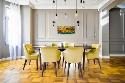 a dining room with a table and yellow chairs at 2bdr Luxury On Prime Location in Sofia