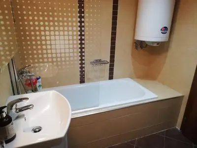 a bathroom with a tub and a sink and a shower at BANSKO WINSLOW INFINITY - Studio in Bansko