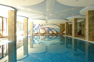 a swimming pool in a building with a mural at BANSKO WINSLOW INFINITY - Studio in Bansko