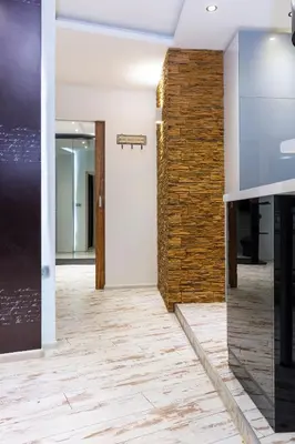 an empty office with a brick wall and a hallway at Modern 1BD Flat with a Parking near the city centre by Flat Mаnager in Plovdiv
