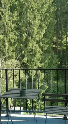 a table and benches on a balcony with trees at GORA - Вила Villa for 22 Guests, Пампорово, Rhodope Mountains in Progled