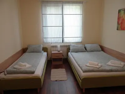 a small room with two beds and a window at Villa Camino in Sapareva Banya